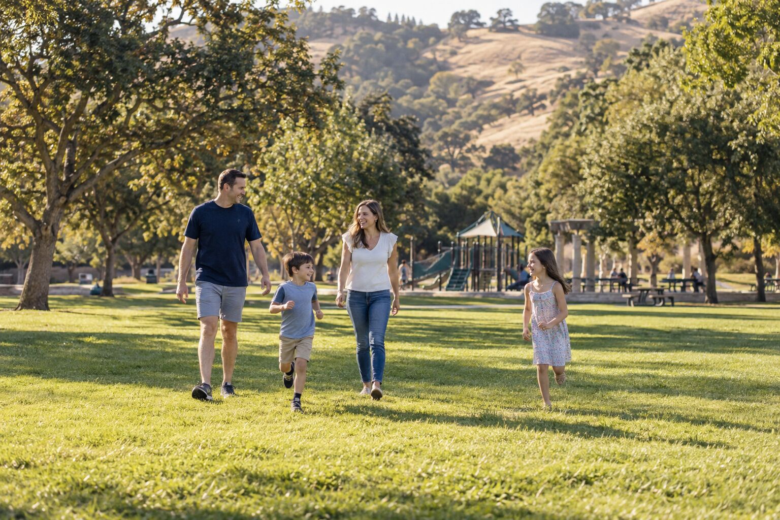 Family walking together in a sunny East Bay park